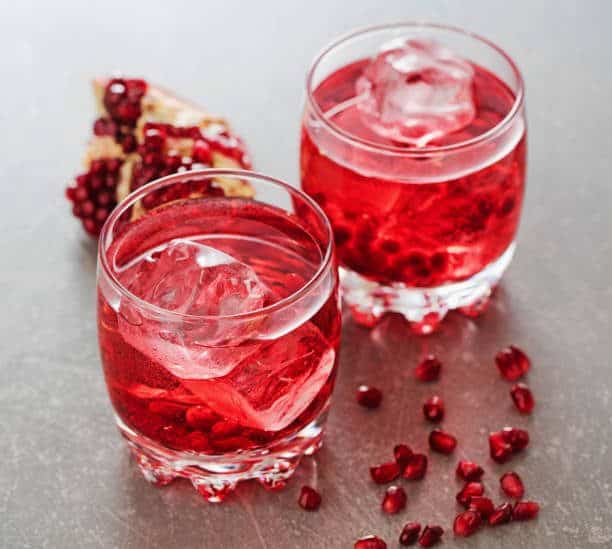 two-glasses-of-pomegranate-cocktail-on-gray-slate-background