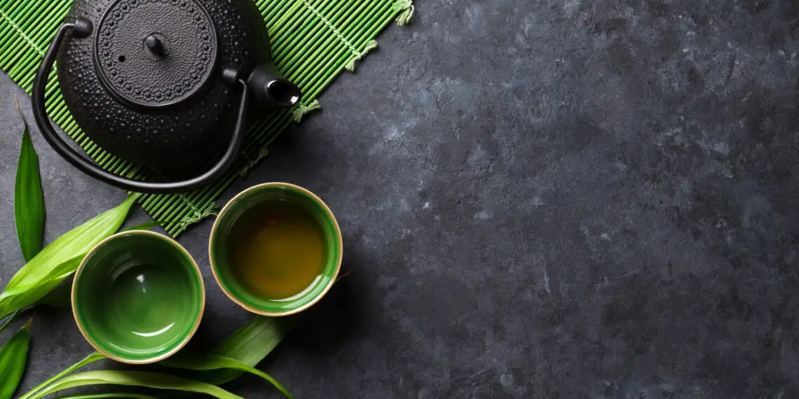 Green japanese tea on stone table. Top view with copy space